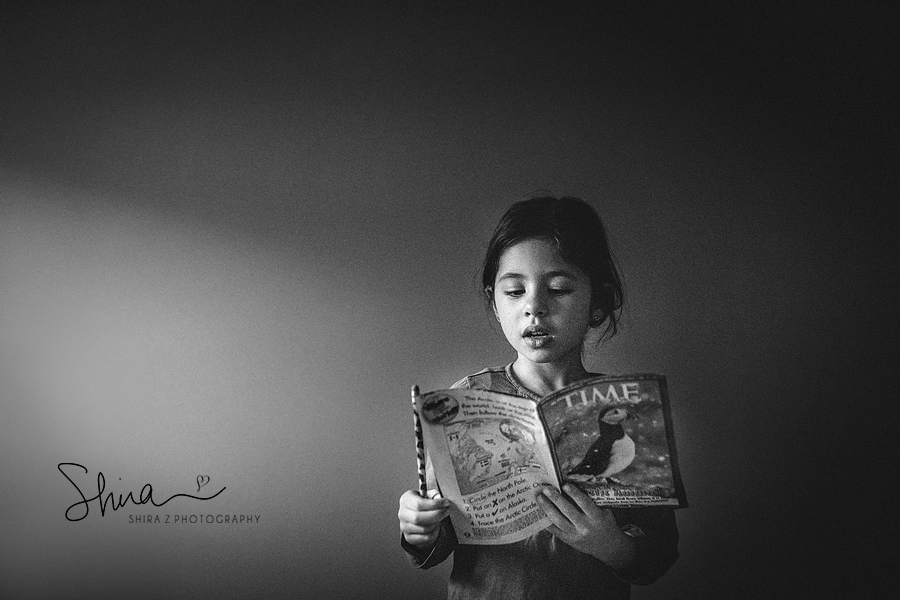 girl reading paper to long island children's photographer