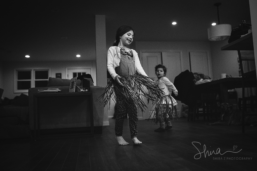 girl dancing hula with a hula skirt for LI Family Photographer