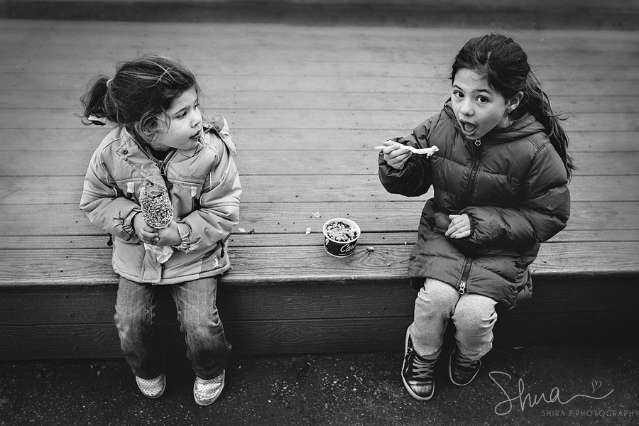 sisters eating ice cream while being photographed by long island family photographer
