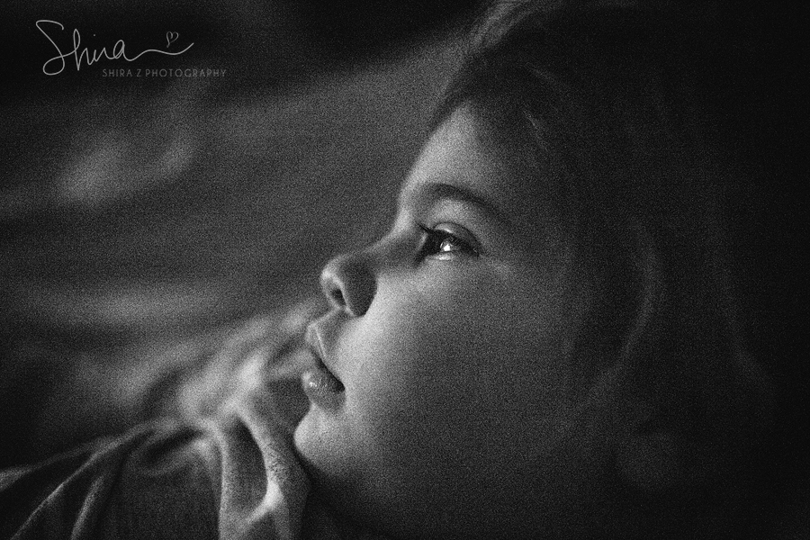 close up black and white photo of 3 year old laying in bed in Long Island, NY
