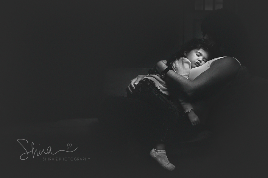 Long Island Mom cuddling with sleeping 3 year old girl in black and white photo